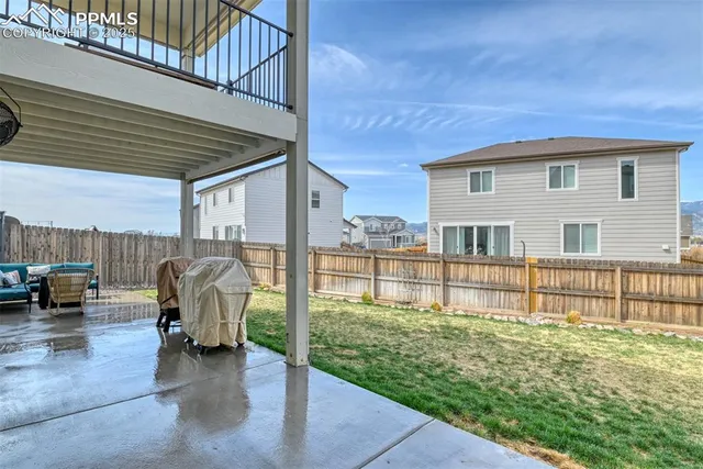 a view of a backyard with table and chairs