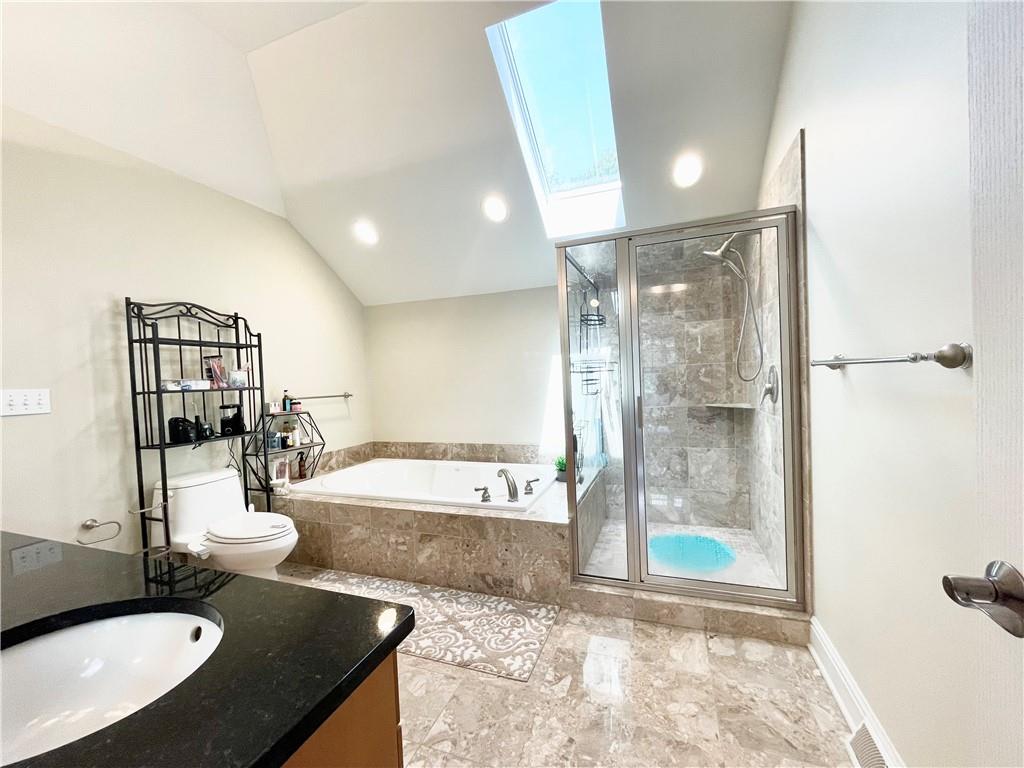 518 Farndale Road Pittsburgh, PA 15215 - Photo 29 of 37 a large bathroom with a granite countertop sink a mirror a bathtub and shower