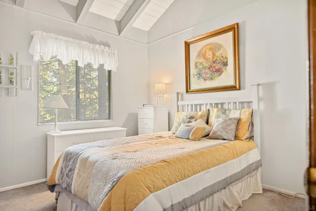 a bedroom with a large bed and a window