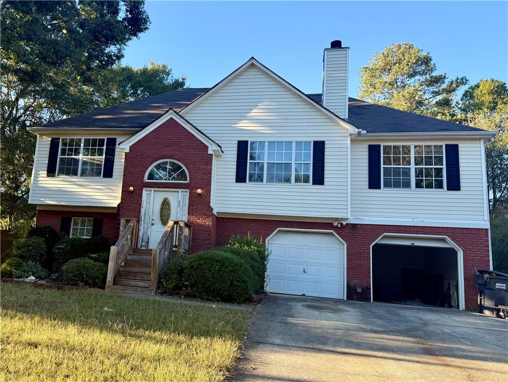 a front view of a house with a yard garage and outdoor seating