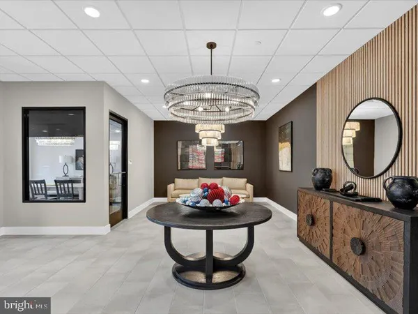 a living room with furniture and a chandelier