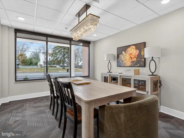 a view of a dining room with furniture large window and wooden floor