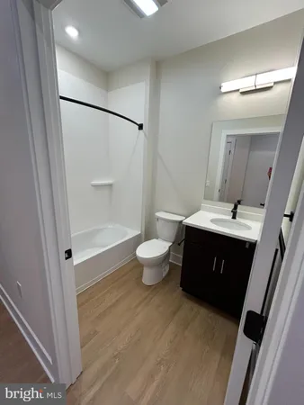 a spacious bathroom with a double vanity sink toilet and a mirror