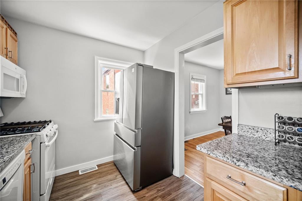 416 Phillips Avenue McKees Rocks, PA 15136 - Photo 16 of 46 a kitchen with stainless steel appliances granite countertop a refrigerator and a stove