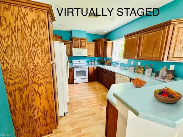 a kitchen with stainless steel appliances granite countertop a sink and cabinets