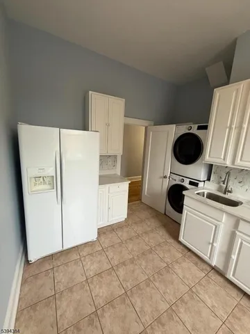 a kitchen with a refrigerator and a stove top oven