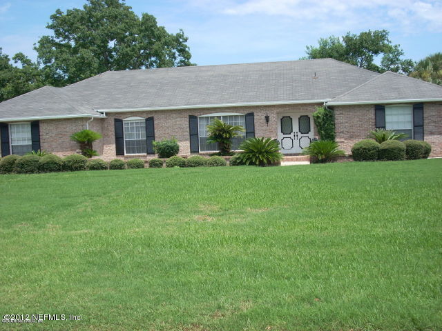 319 Pablo Road Ponte Vedra Beach, FL 32082 - Photo 1 of 4 a front view of a house with a yard and trees