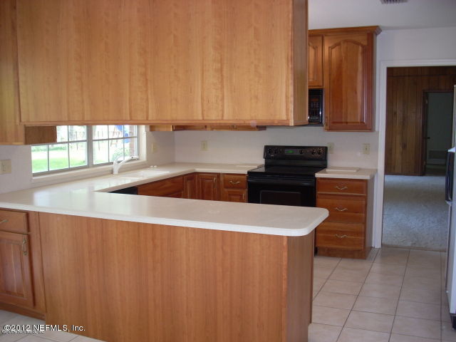 319 Pablo Road Ponte Vedra Beach, FL 32082 - Photo 3 of 4 a kitchen with granite countertop a sink stainless steel appliances and cabinets