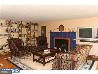 217 Terhune Road Princeton, NJ 08540 - Photo 3 of 12 a living room with furniture a fireplace and a flat screen tv