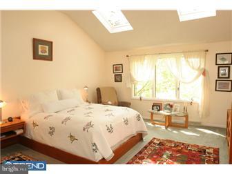 217 Terhune Road Princeton, NJ 08540 - Photo 6 of 12 a bedroom with a bed and wooden floor
