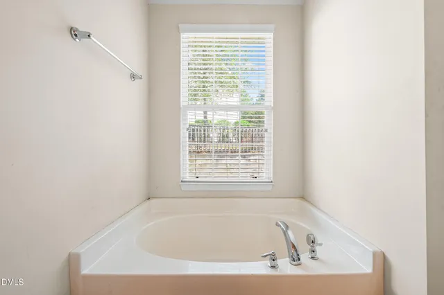 a white bath tub sitting in a bathroom