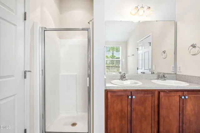 a bathroom with a double vanity sink and a mirror