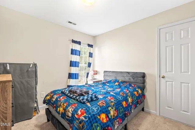 a bedroom with bed and a book shelf