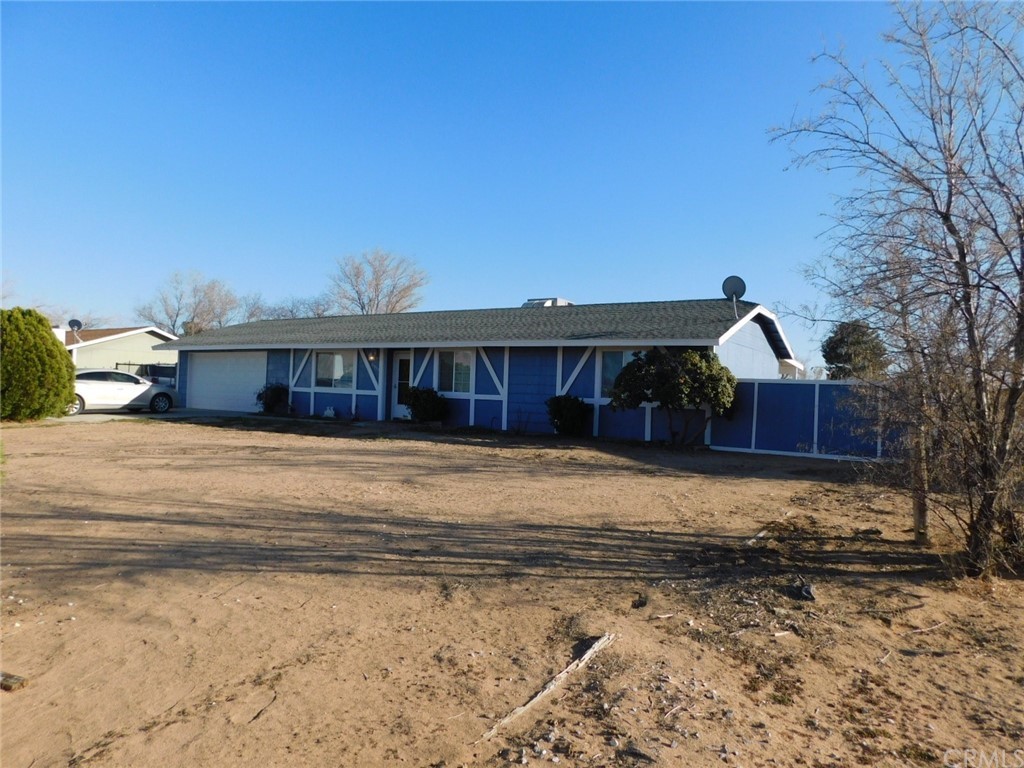 21933 Otoe Road Apple Valley, CA 92307 - Photo 1 of 1 a front view of a house with a yard