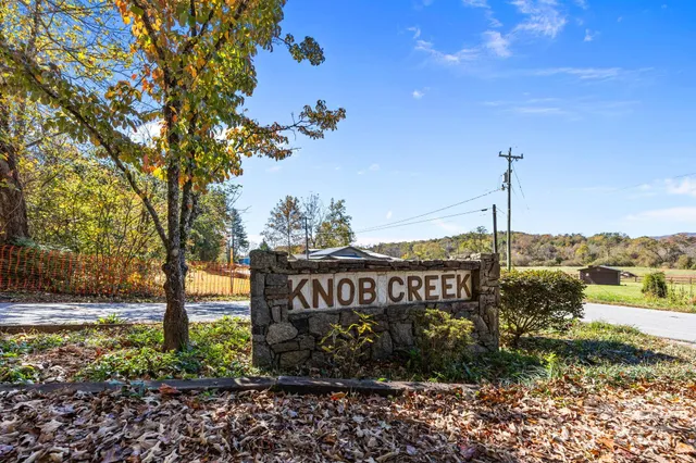 a bathroom with a double vanity sink mirror and shower