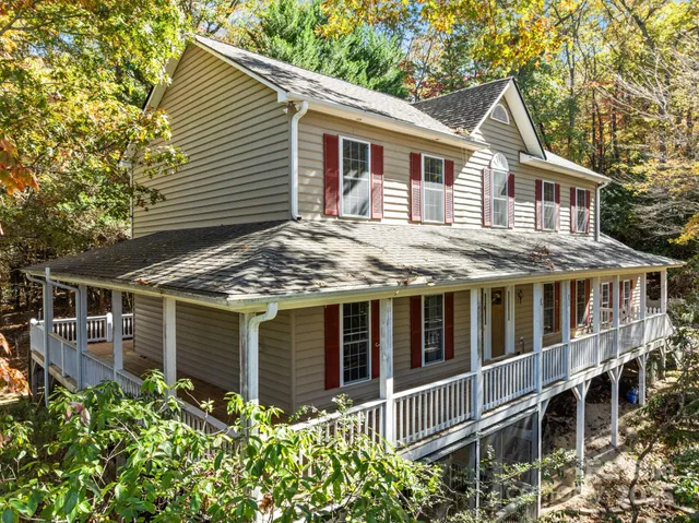 a view of a house with a yard and wooden fence