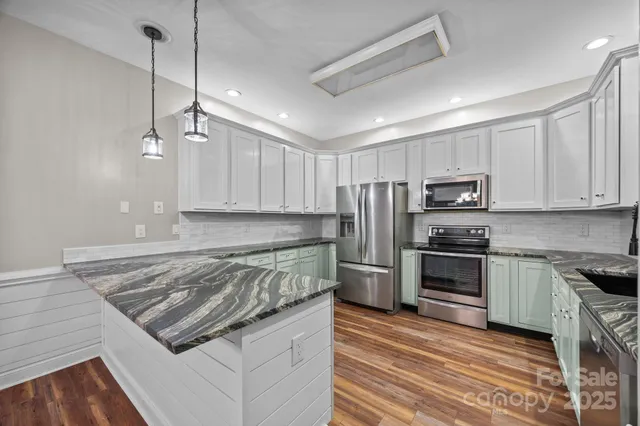 a view of an empty room and wooden floor