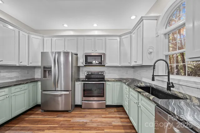 a bathroom with a granite countertop sink mirror and a