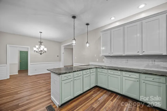 a view of a hallway with wooden floor and stairs