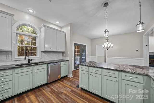 a view of a kitchen with a sink and a stove top oven
