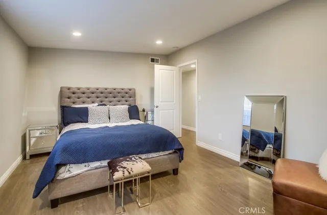 a bedroom with furniture and a wooden floor