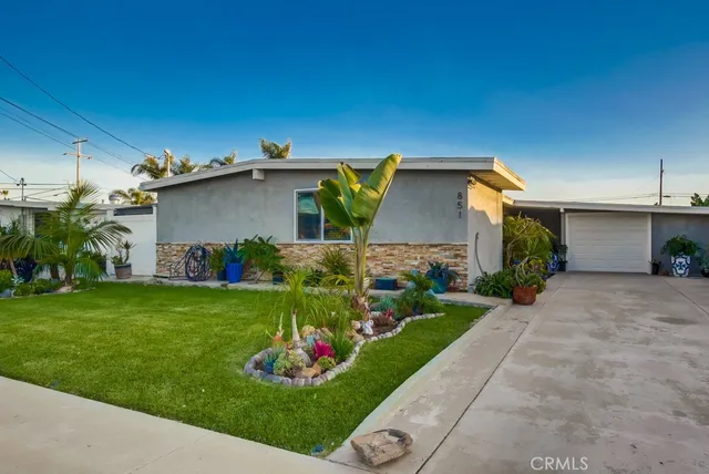 a view of a house with a garden and plants