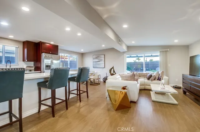 a living room with furniture wooden floor and a table