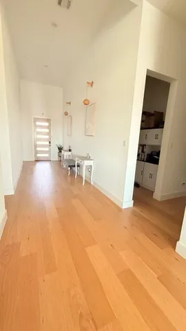 a view of a livingroom with furniture and an empty room