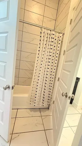 a bathroom with a bathtub and shower