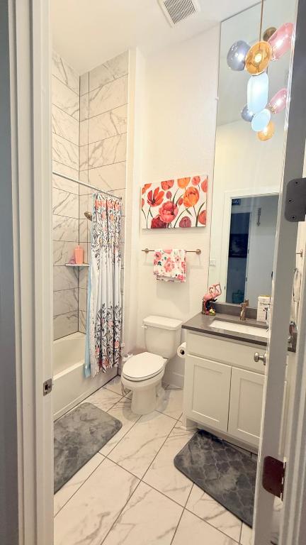 20721 Dustin Lane Pflugerville, TX 78660 - Photo 20 of 27 Bathroom with shower / bath combo, light marble finish flooring, and vanity