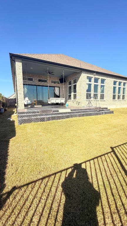 20721 Dustin Lane Pflugerville, TX 78660 - Photo 27 of 27 Back of house with ceiling fan, a patio area, a fenced backyard, and a shingled roof