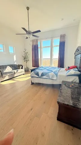 a bedroom with a bed and ceiling fan
