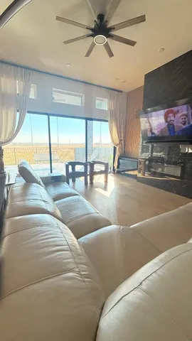 a living room with lots of furniture and a large window