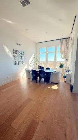 a living room with furniture window and wooden floor