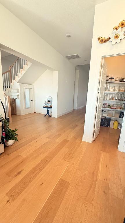 20721 Dustin Lane Pflugerville, TX 78660 - Photo 10 of 27 Unfurnished living room featuring light wood-style floors and stairway