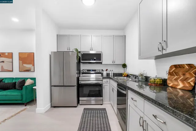 a kitchen with a refrigerator and a sink