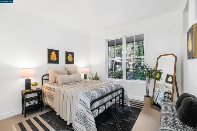 a bedroom with a bed and a large window