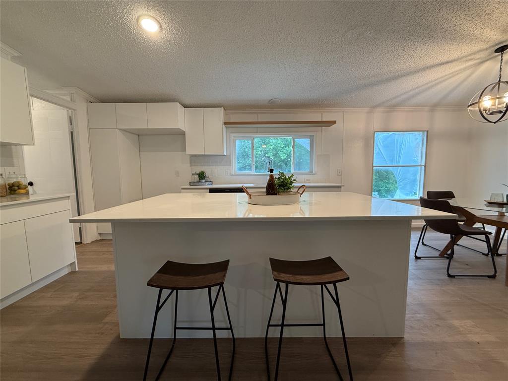 2002 County Road 906 Princeton, TX 75407 - Photo 11 of 31 a kitchen with a table chairs and wooden floor