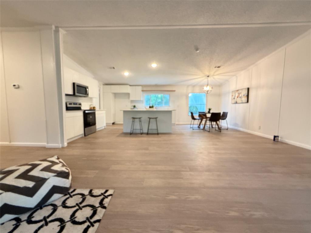 2002 County Road 906 Princeton, TX 75407 - Photo 14 of 31 a living room with furniture and a dining table with kitchen view