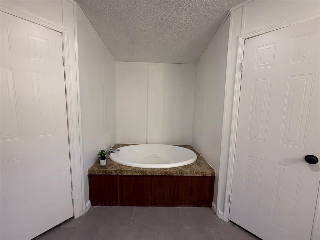 2002 County Road 906 Princeton, TX 75407 - Photo 20 of 31 a bathroom with a sink and a mirror