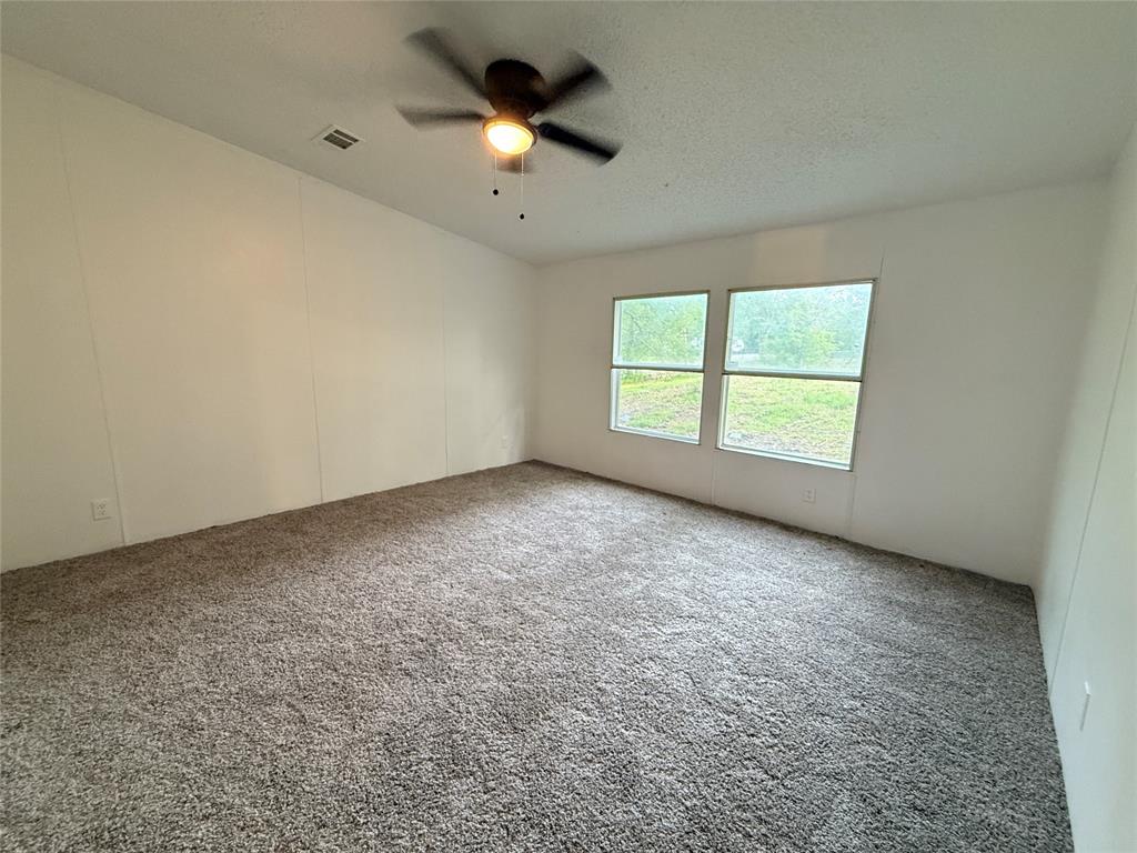 2002 County Road 906 Princeton, TX 75407 - Photo 24 of 31 an empty room with a empty space and a ceiling fan