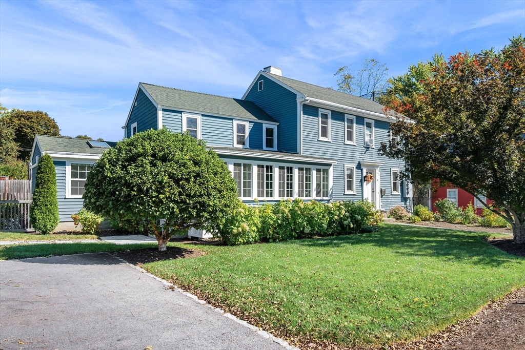 a front view of house with yard and green space