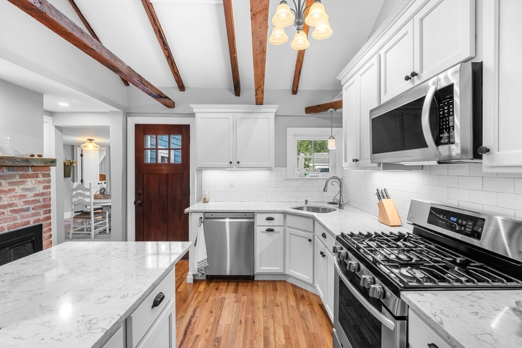 20 Summer Street, Unit 20 Ipswich, MA 01938 - Photo 16 of 42 a kitchen with stainless steel appliances granite countertop a sink stove and refrigerator