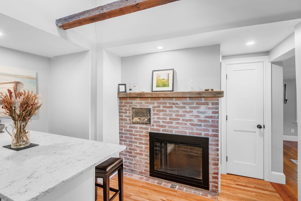 20 Summer Street, Unit 20 Ipswich, MA 01938 - Photo 17 of 42 a living room with a fireplace and wooden floor