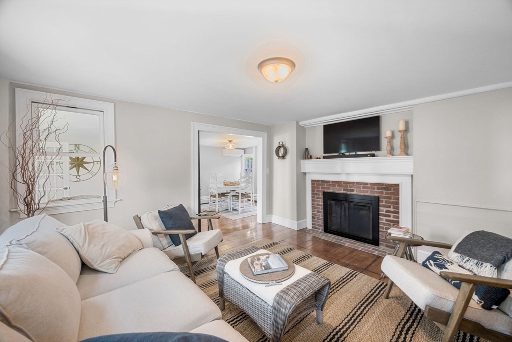 20 Summer Street, Unit 20 Ipswich, MA 01938 - Photo 19 of 42 a living room with furniture a fireplace and a flat screen tv