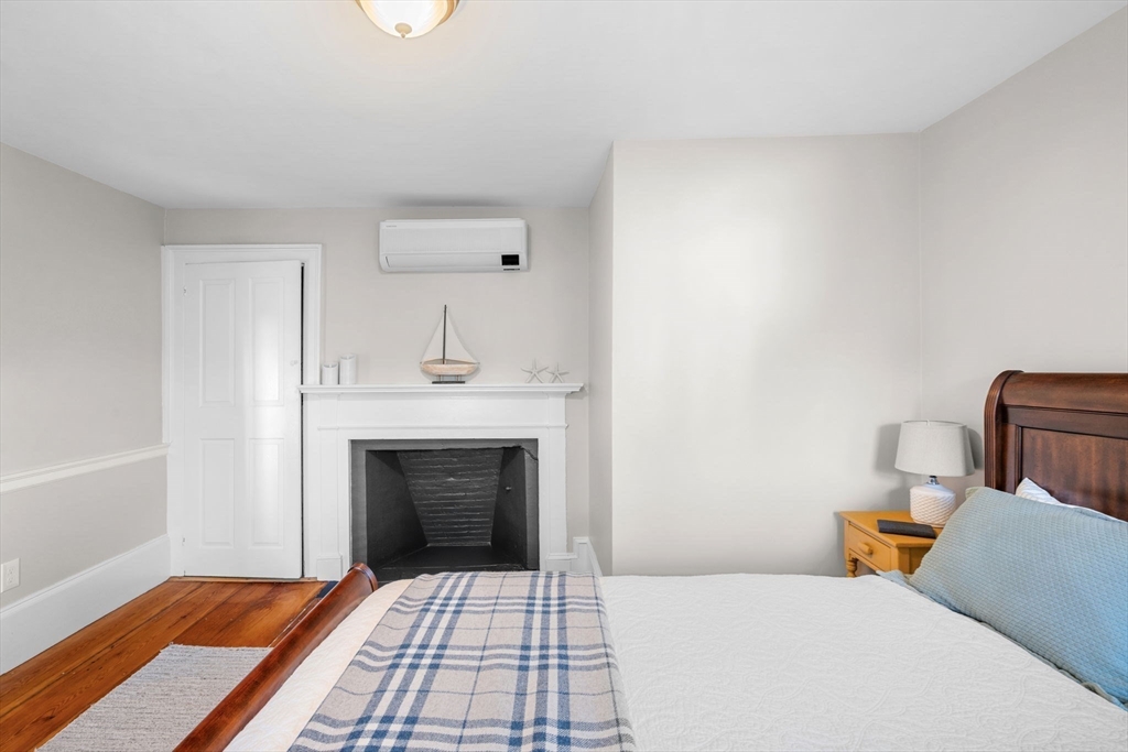 20 Summer Street, Unit 20 Ipswich, MA 01938 - Photo 30 of 42 a bedroom with a bed and a fireplace