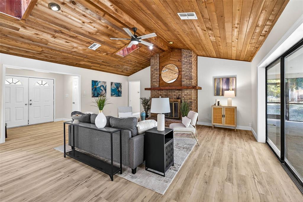 14252 Trinity Road Brooksville, FL 34614 - Photo 3 of 26 a living room with fireplace furniture and a wooden floor