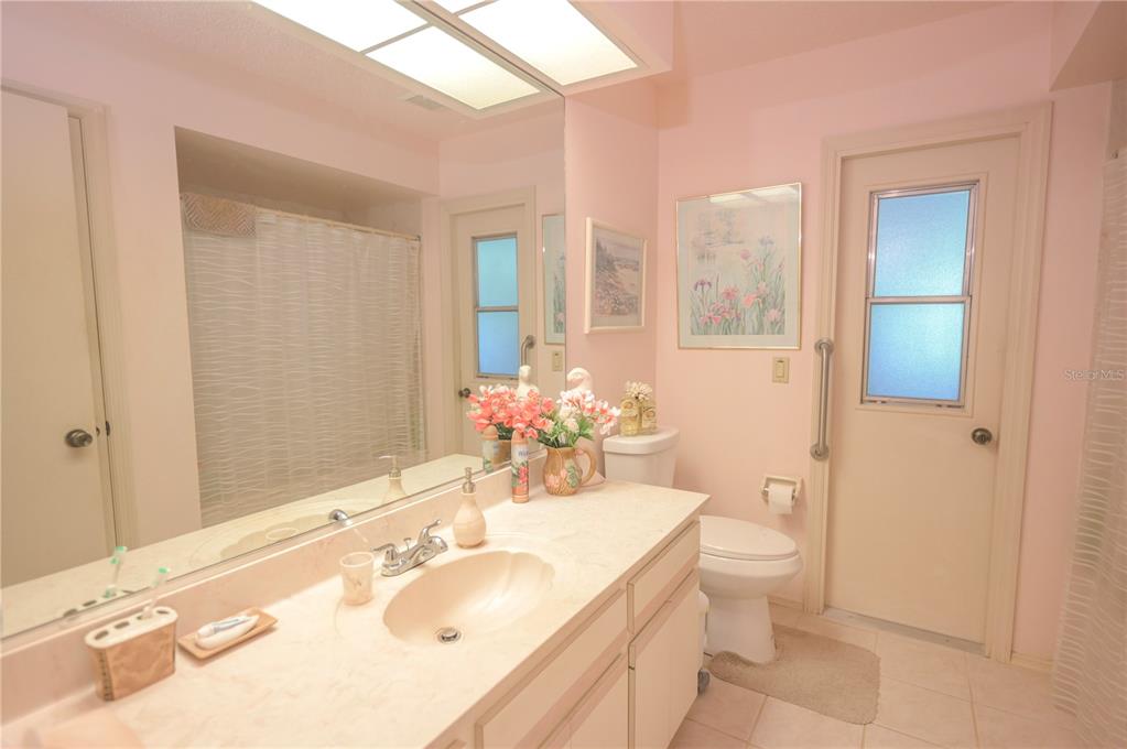 615 Toledo Road North Port, FL 34287 - Photo 12 of 16 a bathroom with a granite countertop sink and a mirror