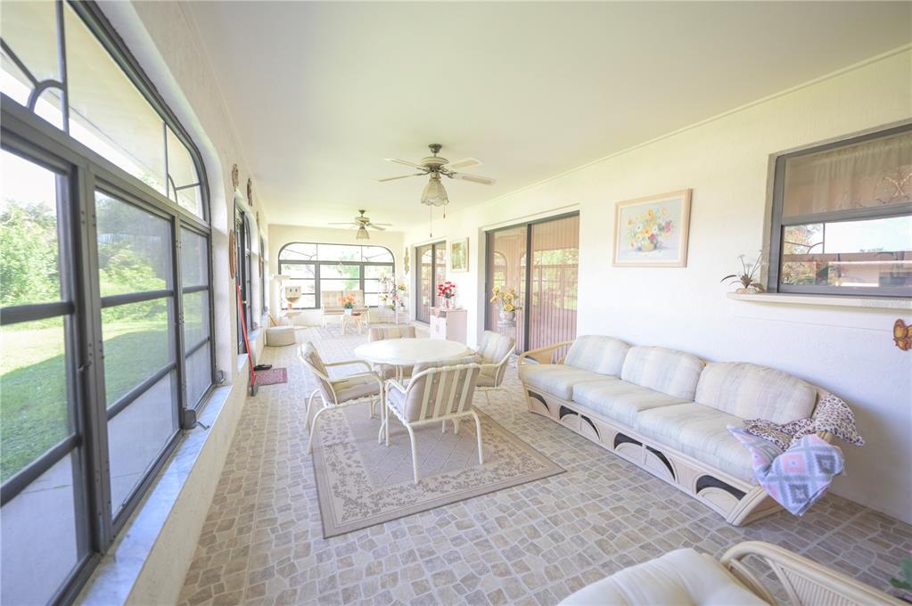 615 Toledo Road North Port, FL 34287 - Photo 14 of 16 a living room with furniture and a large window