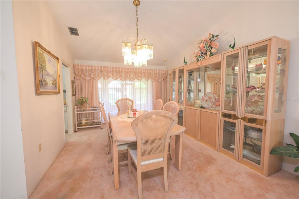 615 Toledo Road North Port, FL 34287 - Photo 6 of 16 a view of a dining room with furniture and chandelier